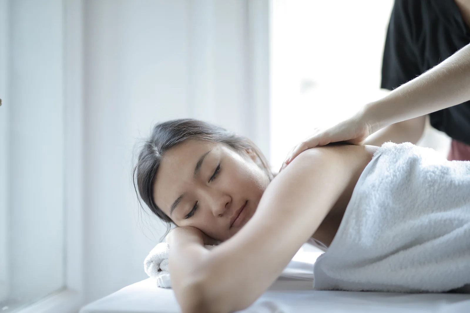 Professional full body massage in a bright spa setting